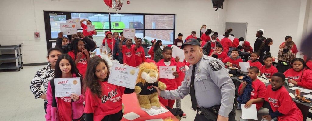 Photo of kids with D.A.R.E. certificates left section.